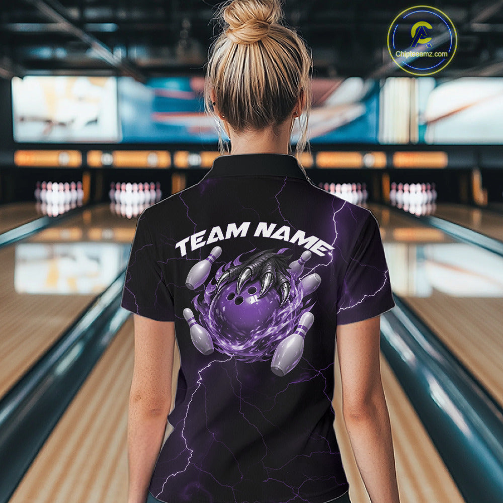 Back view of a black and purple womens bowling polo displaying a flaming bowling ball held by a dragon claw.