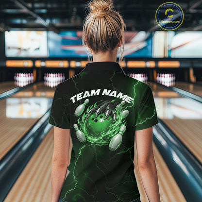 Back view of a black and green womens quarter-zip showcasing a flaming bowling ball and dragon claw motif.