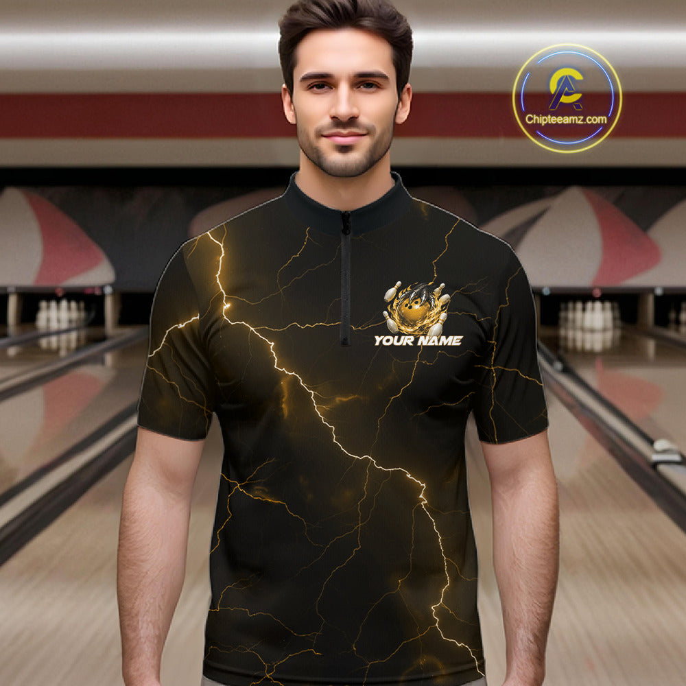 Male model wearing a black and yellow bowling quarter-zip with dragon claw artwork, flaming bowling ball, and lightning fantasy background.
