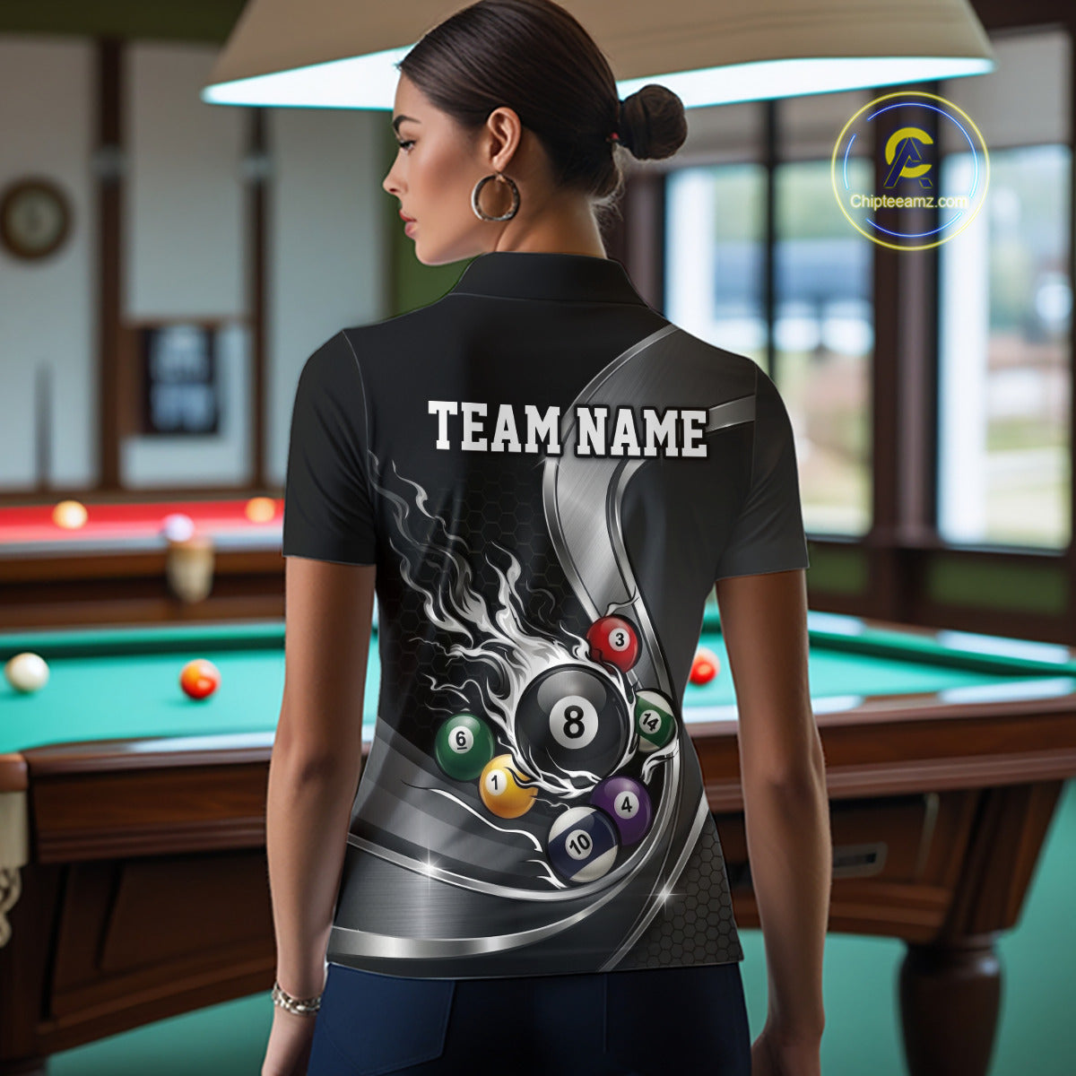 Back view of a female model in a black and silver billiard polo featuring metallic ribbons, a dark honeycomb pattern, and a flaming 8-ball