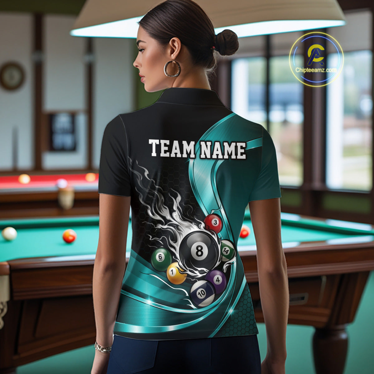 Back view of a female model wearing a black and blue billiard polo with metallic ribbon artwork, dark honeycomb graphics, and a flaming 8-ball