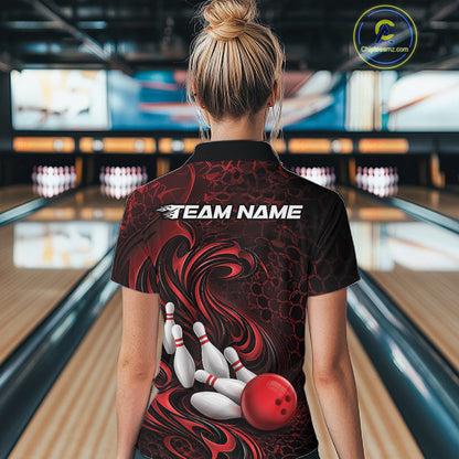 Back view of a female model wearing a black and red bowling quarter-zip shirt in a bowling alley featuring a tribal flame bowling ball and pins graphic