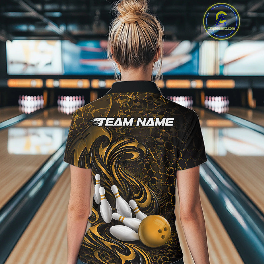 Back view of a female model wearing a black and yellow bowling quarter-zip shirt in a bowling alley featuring a tribal flame bowling ball and pins graphic