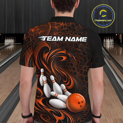 Male model standing in a bowling lane showing the back of a black and orange bowling polo shirt with a tribal flame bowling ball and pins graphic.