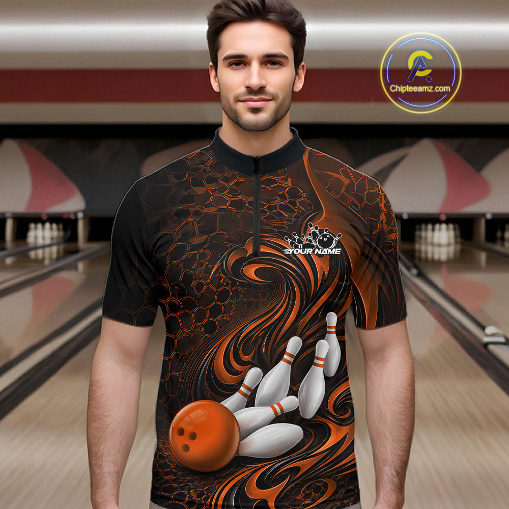 Male model standing in a bowling lane wearing a black and orange bowling quarter-zip shirt featuring a tribal flame bowling ball and pins graphic on the front.