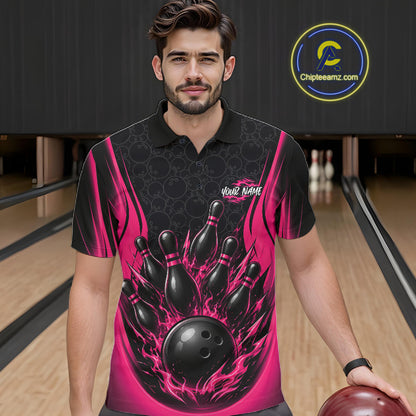 A man wearing a black and pink bowling-themed short-sleeve polo shirt, standing in a bowling alley with bowling pins and lanes visible in the background. 