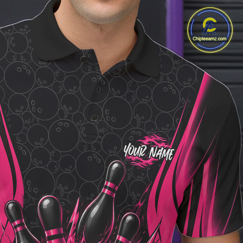 A close-up of a person wearing a black short-sleeve polo shirt with bowling-themed graphics, including bowling pins, bowling balls, and pink flame-like side panels. 