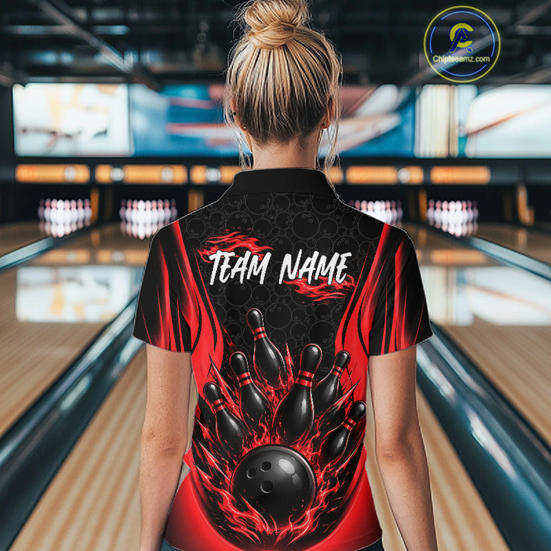 A woman viewed from behind wearing a black and red bowling-themed short-sleeve quarter zip shirt with a large bowling pin and ball graphic and the text 'TEAM NAME' on the back, standing in a bowling alley.