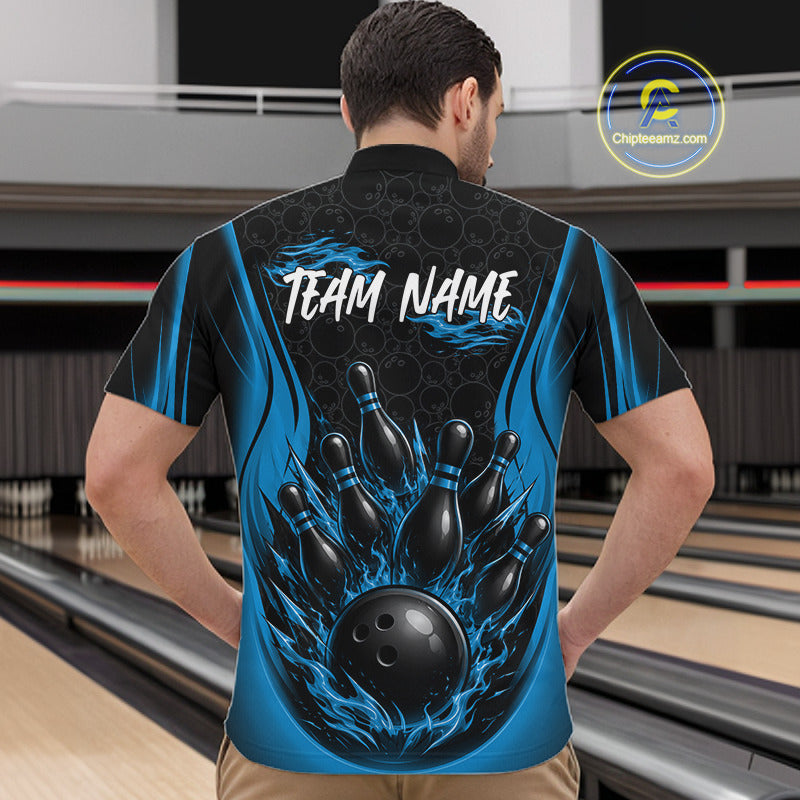 A man viewed from behind wearing a custom bowling-themed short-sleeve shirt with a black and blue flame design, a black bowling pin cluster, a bowling ball, and the text 'TEAM NAME' printed on the back. The background shows bowling lanes.