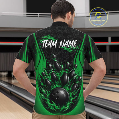 A man viewed from behind wearing a custom bowling-themed short-sleeve shirt with a black and green flame design, bowling pins, a bowling ball, and 'TEAM NAME' printed on the back. The background shows a blurred bowling alley.