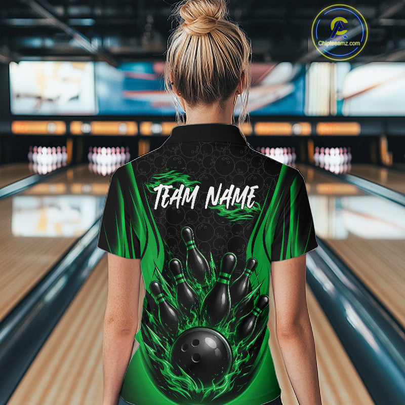 A woman viewed from behind wearing a custom bowling quarter zip shirt with a black and green flame graphic, a bowling pin design, and the text 'TEAM NAME' on the back. 