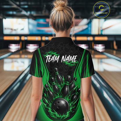 A woman viewed from behind wearing a custom bowling quarter zip shirt with a black and green flame graphic, a bowling pin design, and the text 'TEAM NAME' on the back. 