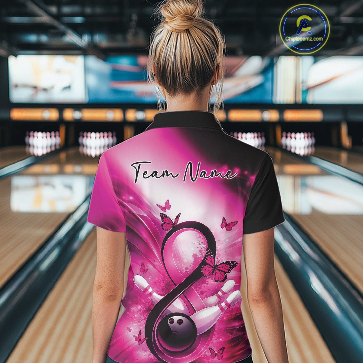 Back view of a bowling quarter-zip displaying butterfly details, bowling pins, and a pink ribbon graphic.