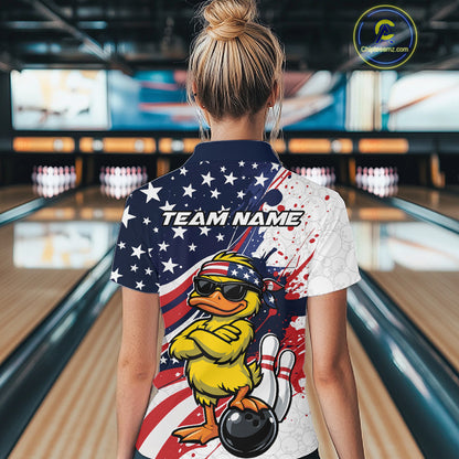 Female model shown from the back in a bowling lane wearing a bowling polo featuring a patriotic duck and bowling ball motif.