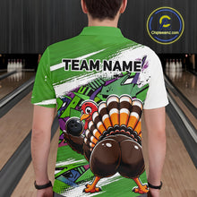 Load image into Gallery viewer, Back view of a male model wearing a green custom bowling polo shirt featuring a funny graffiti style turkey holding a bowling ball, paint splatter details, and a custom name in a bowling alley.