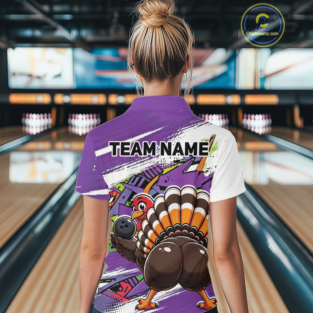 Back view of a female model wearing a purple custom bowling polo shirt with a funny graffiti turkey holding a bowling ball, paint splatter accents, and a personalized name in a bowling alley.