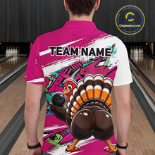Load image into Gallery viewer, Back view of a male model wearing a pink custom bowling polo shirt with a funny graffiti turkey holding a bowling ball, paint splatter accents, and a personalized name in a bowling alley.