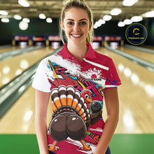 Load image into Gallery viewer, Front view of a female model wearing a red custom bowling polo shirt with a funny graffiti turkey holding a bowling ball, paint splatter accents, and a personalized name in a bowling alley.