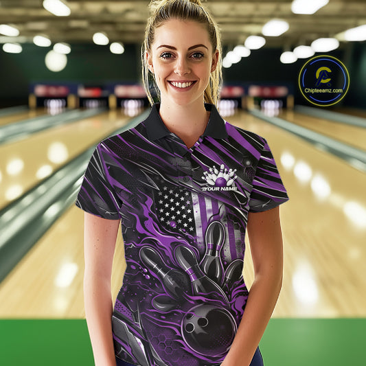 Female model at a bowling lane wearing a black and purple bowling polo shirt with patriotic bowling strike artwork and flag-inspired graphics.