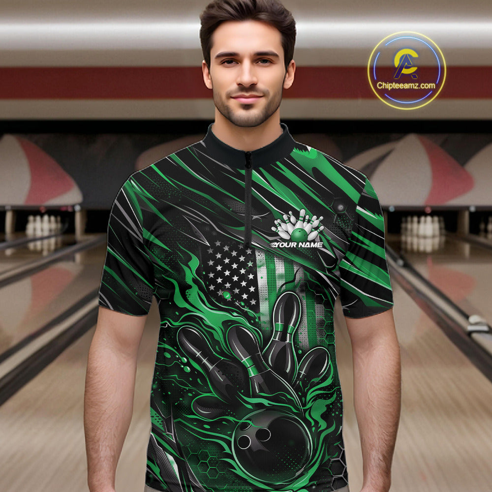 Male model at a bowling lane wearing a black and green bowling quarter-zip shirt with patriotic bowling strike artwork and flag-inspired accents.