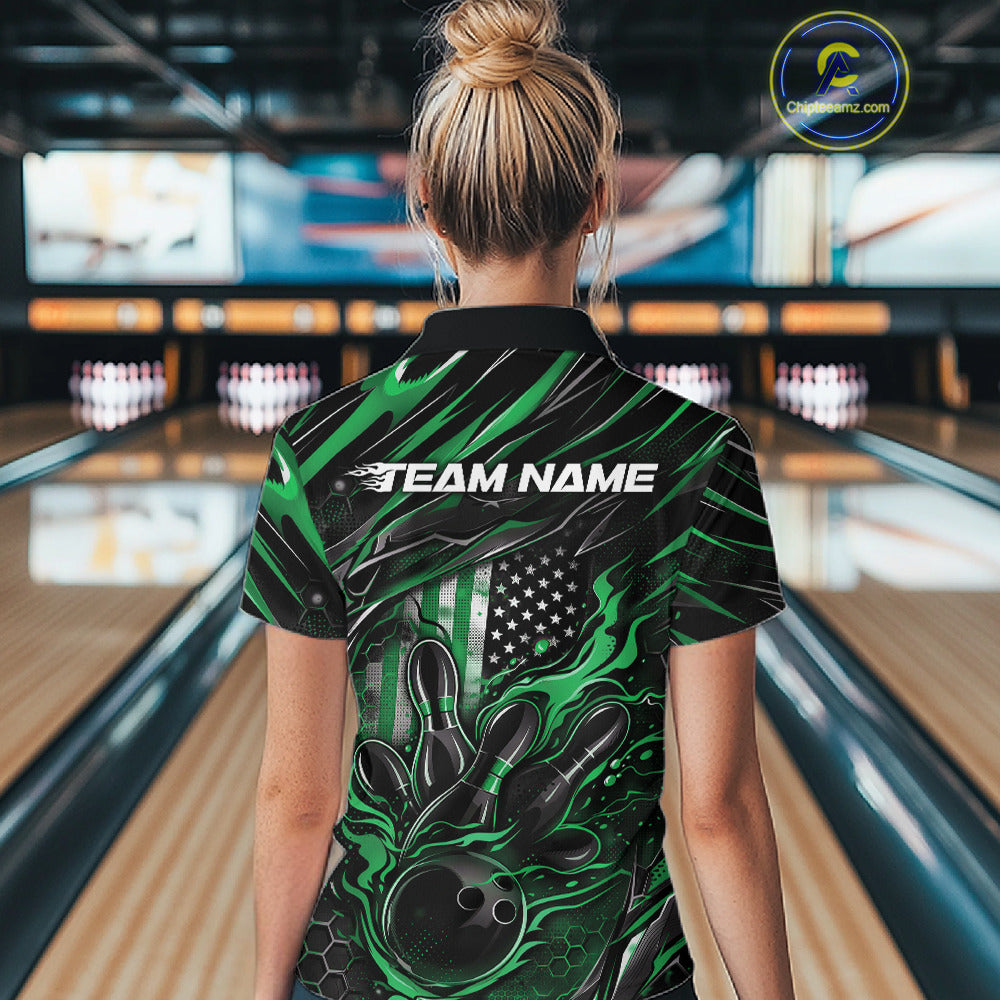 Female model inside a bowling venue, back view of black and green quarter zip shirt showcasing patriotic flames bowling ball striking pins with flag-inspired accents