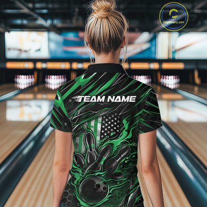Female model inside a bowling venue, back view of black and green quarter zip shirt showcasing patriotic flames bowling ball striking pins with flag-inspired accents