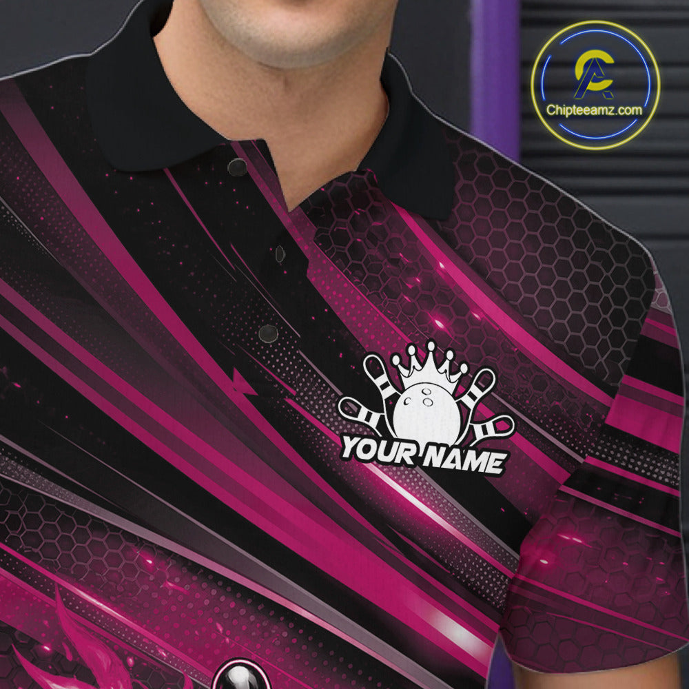Close-up left chest detail of a black and pink bowling polo shirt featuring a fiery bowling ball and pin artwork with abstract stripes.