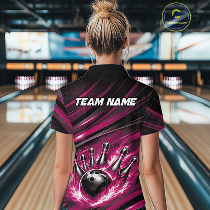 Female model at a bowling lane, back view of black and pink quarter zip shirt featuring fiery bowling ball striking pins with abstract stripe accents