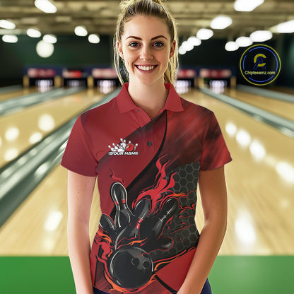 Female model wearing a black and red bowling polo shirt at a bowling lane with fiery bowling action artwork and geometric styling.