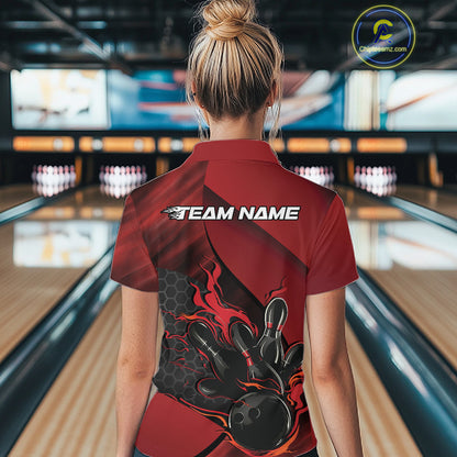 Female model at a bowling lane, back view of black and red quarter zip shirt displaying flames bowling ball striking pins with geometric hexagon pattern