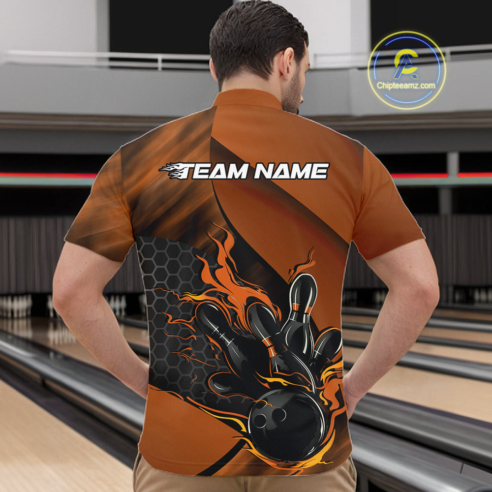 Front view of a male model in a bowling venue wearing a black and orange quarter-zip shirt featuring a flaming bowling ball and pin graphics.