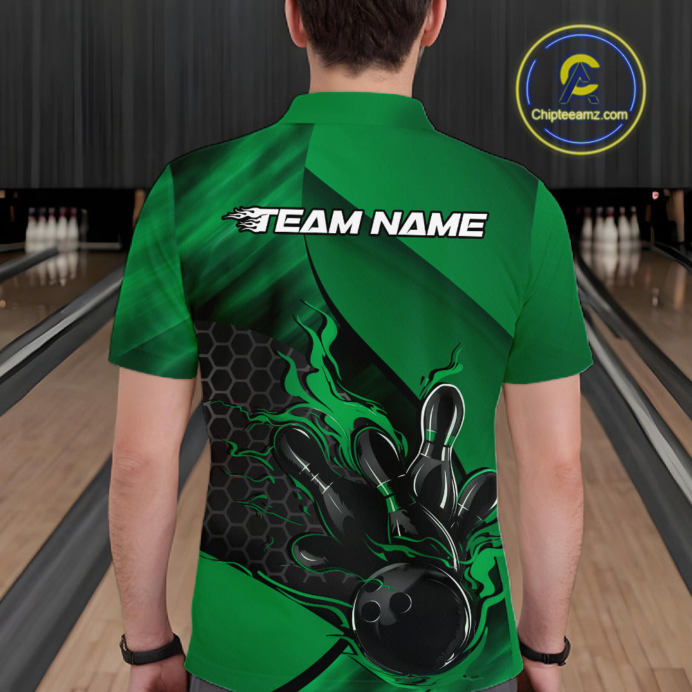 Back view of a male model in a bowling venue wearing a black and green polo shirt featuring a flaming bowling ball and pin motif.