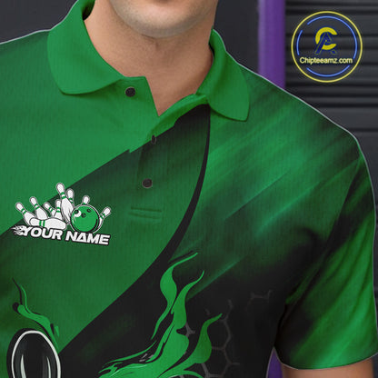 Close-up left chest view of a black and green bowling polo shirt featuring a flaming bowling ball striking pins over a hexagon pattern.