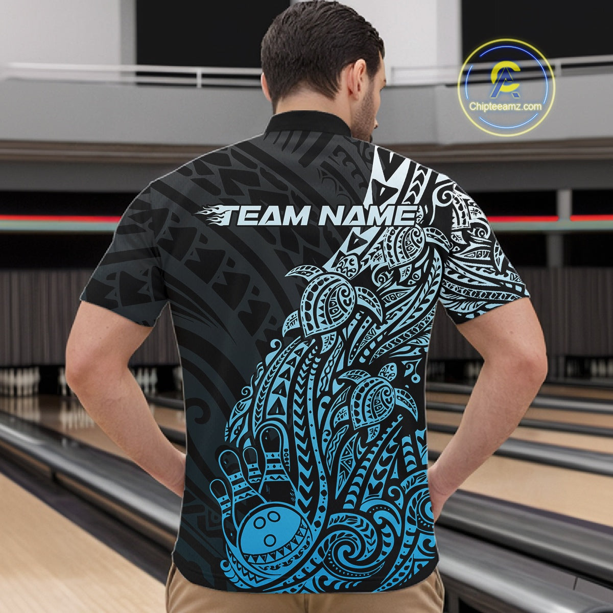 Front view of a male model in a black and blue bowling quarter-zip shirt displaying tribal swirl bowling motifs.