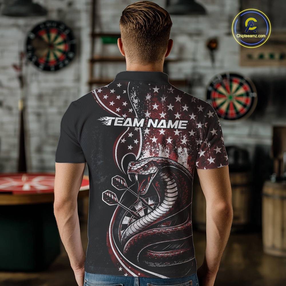 Male model showcasing the back design of a custom red and black stars and stripes patriotic cobra snake men's dart polo shirt with a customizable "TEAM NAME" text template in an indoor setting.