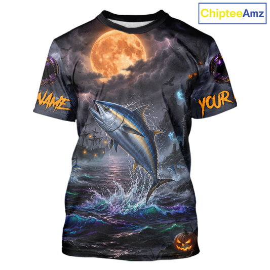 A custom short-sleeve t-shirt with an all-over Halloween-themed graphic print. The design features a large blue tuna jumping out of dark, stormy water under a glowing orange full moon, with customizable text placeholders 'NAME' and 'YOUR' on the sleeves, and a jack-o'-lantern at the bottom right.