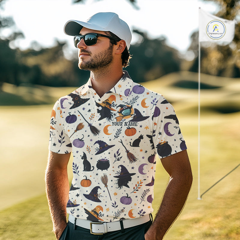 A man wearing a white short-sleeve polo shirt with a Halloween-themed print of witches' hats, cauldrons, broomsticks, pumpkins, and moons, standing on a golf course. He is wearing a white cap, sunglasses, and a white belt, with a golf flag visible in the background.