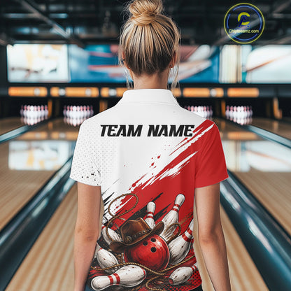 A woman stands in a bowling alley wearing a custom short-sleeve polo shirt with a red and white graphic design featuring bowling pins, bowling balls, and a bowler's hat. The shirt has a white upper chest and shoulder area with red paint-like brushstrokes, a black and white bowling pin graphic, and a red bowling ball with a brown hat.