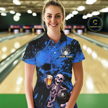 Load image into Gallery viewer, Person wearing a blue and black bowling shirt with a skeleton design in a bowling alley.