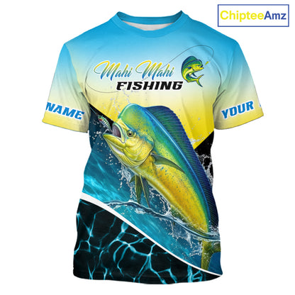 A short-sleeve graphic t-shirt featuring a Mahi Mahi fishing design. The shirt has a blue-to-yellow gradient top half with 'Mahi Mahi FISHING' text and a fish logo, and a large realistic mahi-mahi fish graphic on the front.