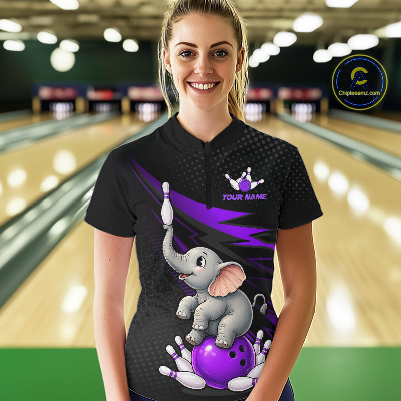 A woman stands in a bowling alley wearing a black short-sleeve bowling shirt with a cartoon elephant balancing a purple bowling ball on its trunk, purple lightning accents, and a small crown logo above the text 'YOUR NAME'. A circular 'Chilewich.
