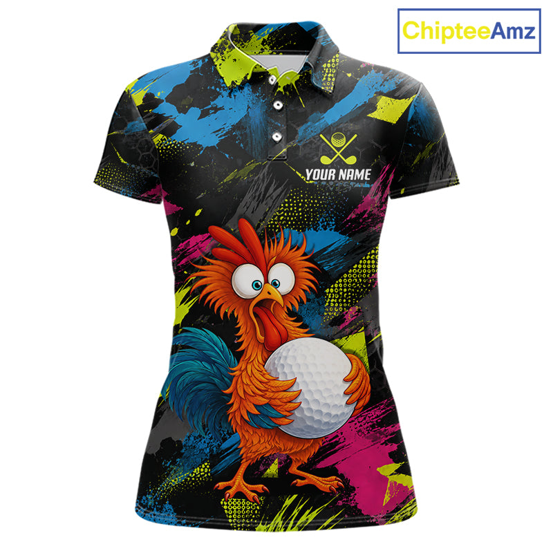 A women's short-sleeve polo shirt with a vibrant, colorful all-over print featuring a cartoon rooster holding a golf ball. The shirt has a black base with bright splashes of blue, pink, yellow, and green, and includes a customizable name and logo print on the chest.