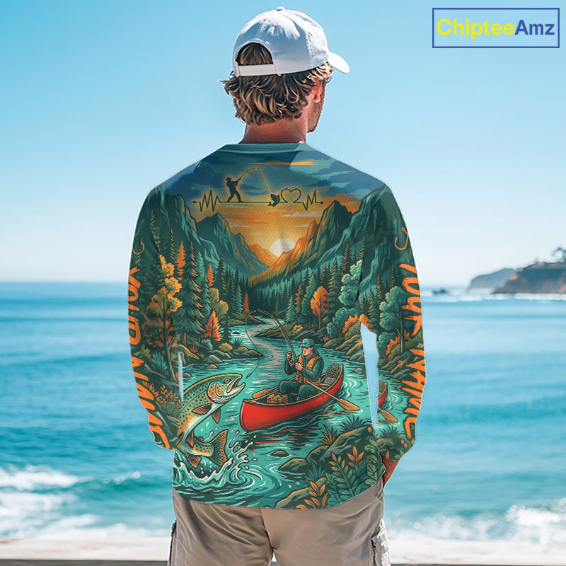Person wearing a long-sleeve shirt with a nature-themed design by the ocean.