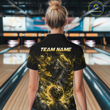 Load image into Gallery viewer, Woman wearing a black and yellow shirt with a design of a skeleton holding a bowling ball in a bowling alley.