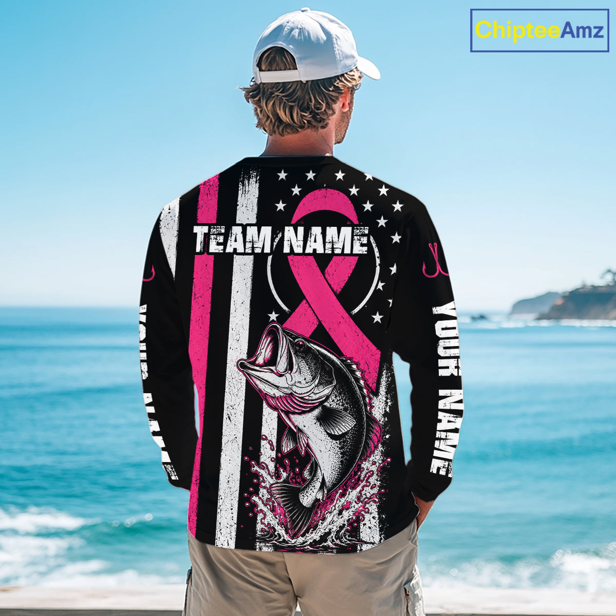 A man stands on a beach facing the ocean, wearing a black long-sleeve graphic shirt with a pink ribbon, fish illustration, and customizable text. A 'ChijiseeAmz' watermark is visible in the top right corner.