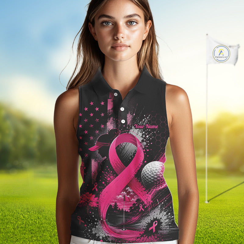A woman modeling a sleeveless polo shirt with a black and pink breast cancer awareness design featuring a ribbon, golf ball, and stars, set against a blurred golf course background.