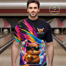 Load image into Gallery viewer, Man wearing a colorful bowling shirt with a capybara design in a bowling alley.