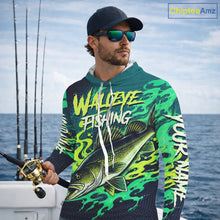 Load image into Gallery viewer, Angler wearing custom Walleye fishing green camo long sleeve hooded fishing shirt on the boat