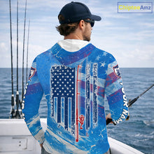 Load image into Gallery viewer, Man on a boat wearing a blue American flag largemouth bass hooded fishing shirt with custom name on the sleeves