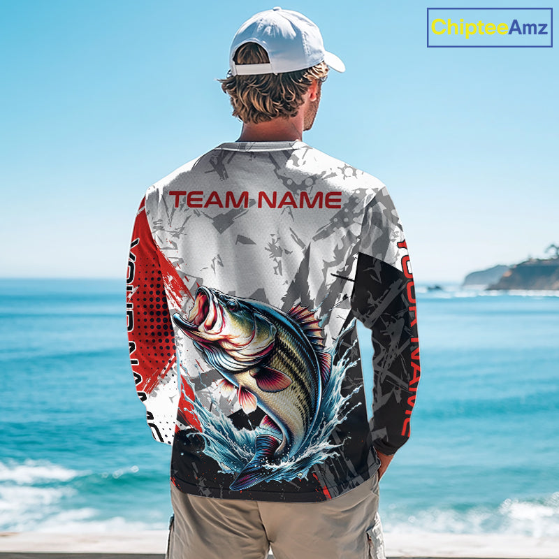 A man wearing a bass fishing shirt long sleeve with a large fish graphic and 'TEAM NAME' text, standing by the ocean.
